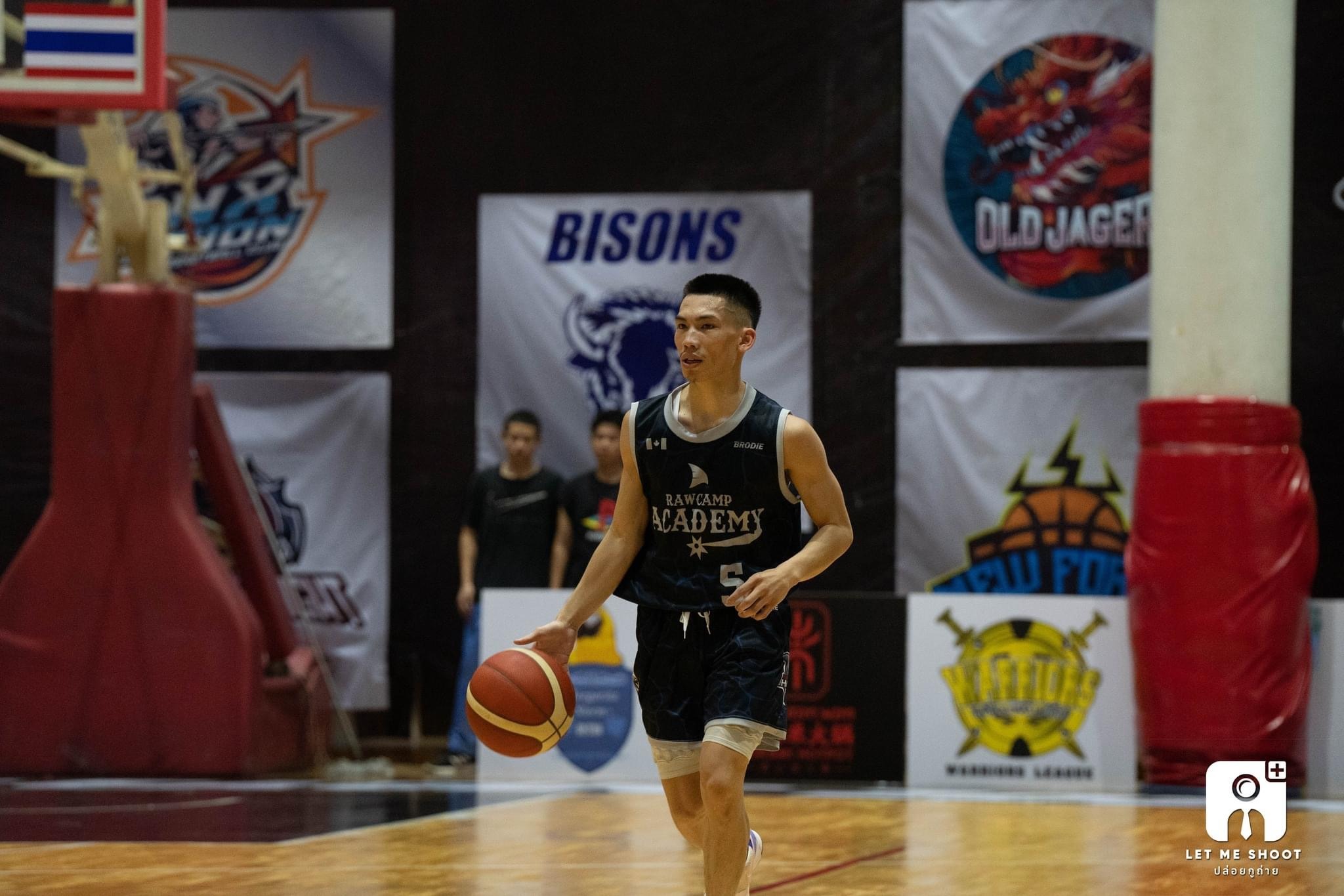 Coach Jexter Evangelista dribbling a basketball on the court
